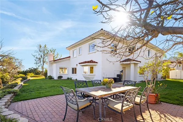 a view of a house with backyard and sitting area
