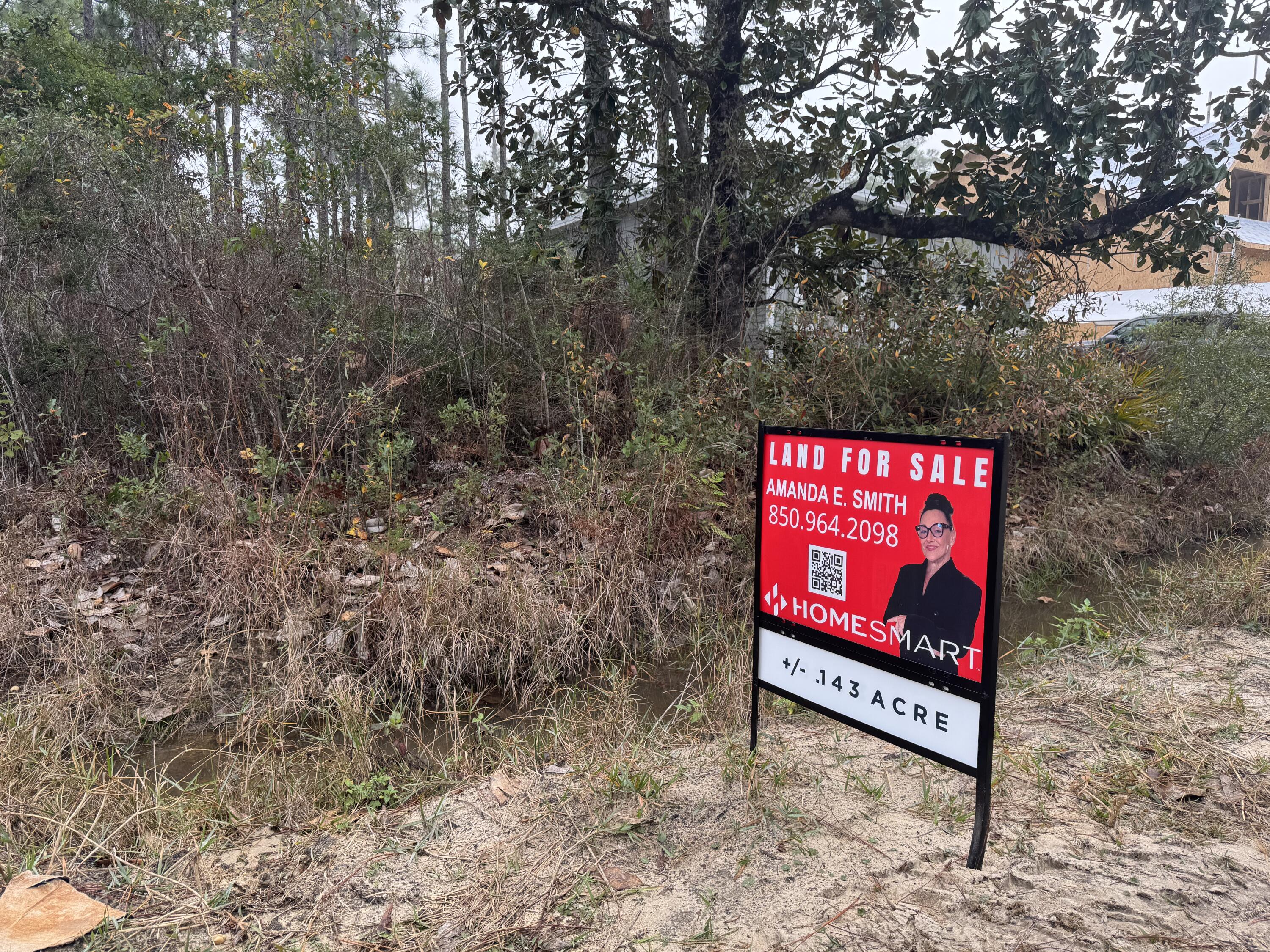 0 L Street Santa Rosa Beach, FL 32459 - Photo 6 of 6 a sign that is sitting on a brick wall