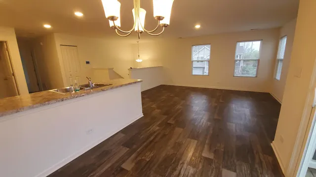 a view of a kitchen counter space and wooden floor