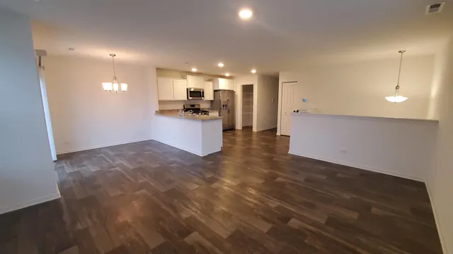 a view of a kitchen with a sink and a refrigerator