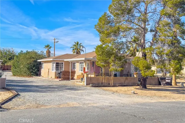 a view of a house with snow on the road