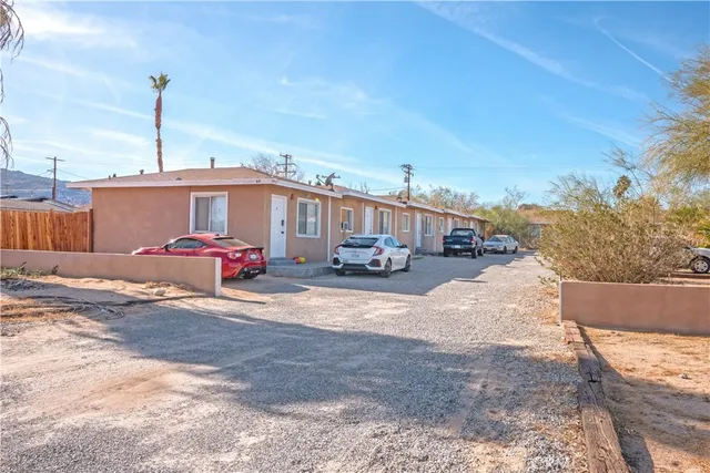 a view of a house with backyard and sitting area
