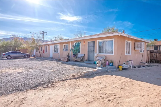 a front view of a building with trees