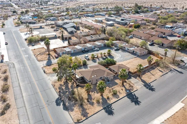 an aerial view of a house with a yard