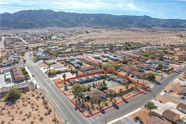 an aerial view of residential house and sandy dunes
