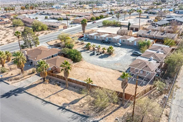an aerial view of residential houses with outdoor space