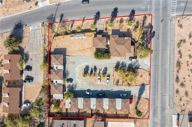 an aerial view of residential houses with yard