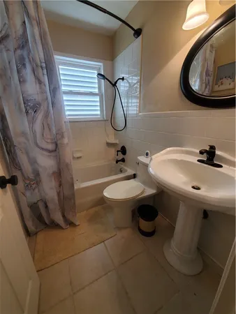 a view of a storage and utility room with washer and dryer