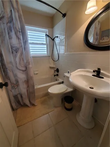 a bathroom with a sink toilet and mirror