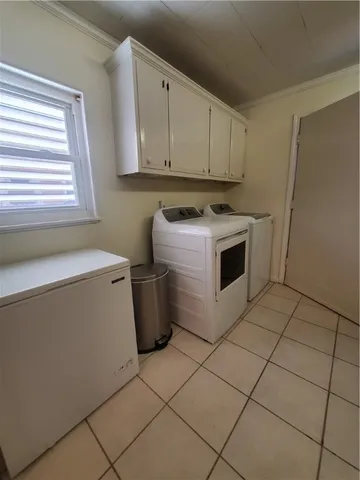 a view of a storage and utility room with washer and dryer