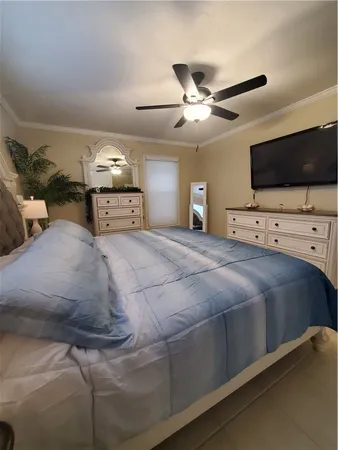 a living room with a bed furniture and a ceiling fan