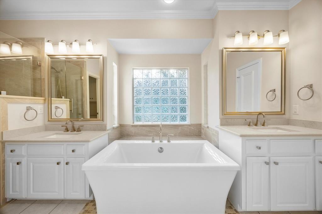 5411 Ranger Drive Rockwall, TX 75032 - Photo 13 of 25 a white bath tub sitting next to a bathroom sink