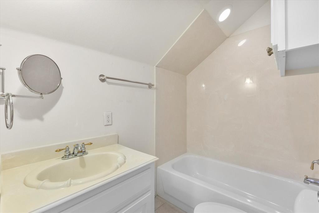 5411 Ranger Drive Rockwall, TX 75032 - Photo 17 of 25 a bathroom with a sink and a mirror