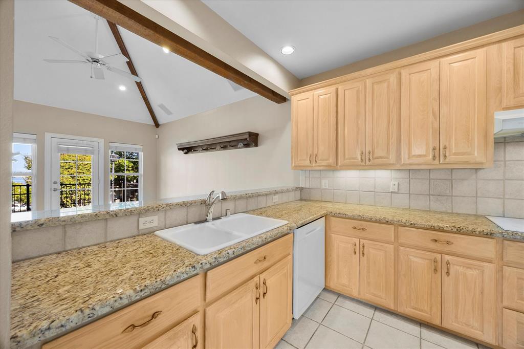 5411 Ranger Drive Rockwall, TX 75032 - Photo 10 of 25 a kitchen with sink cabinets and window