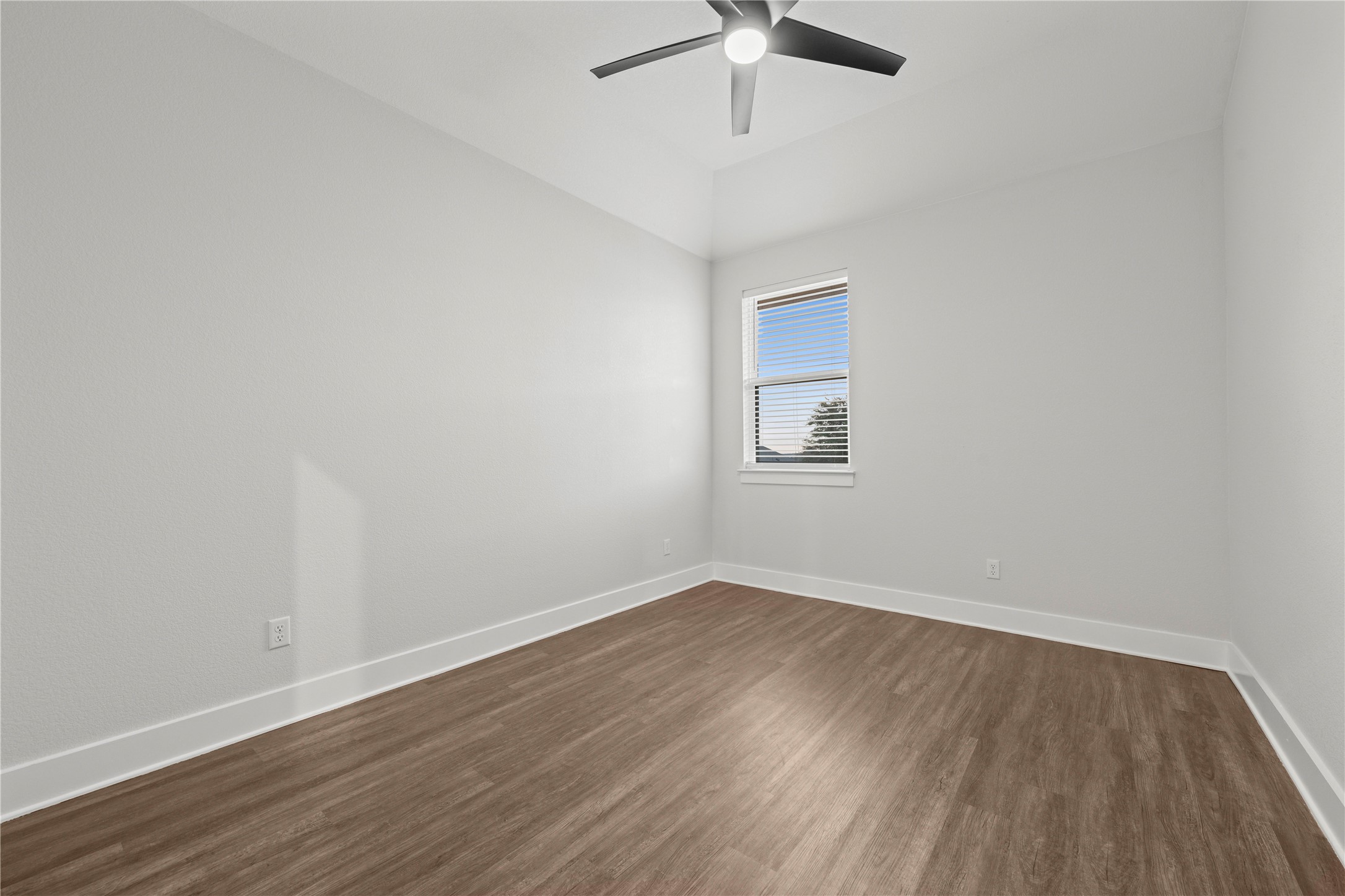 60 Rancho Trail Georgetown, TX 78628 - Photo 25 of 36 Smooth wood-look flooring and a single window define this minimalist secondary bedroom.