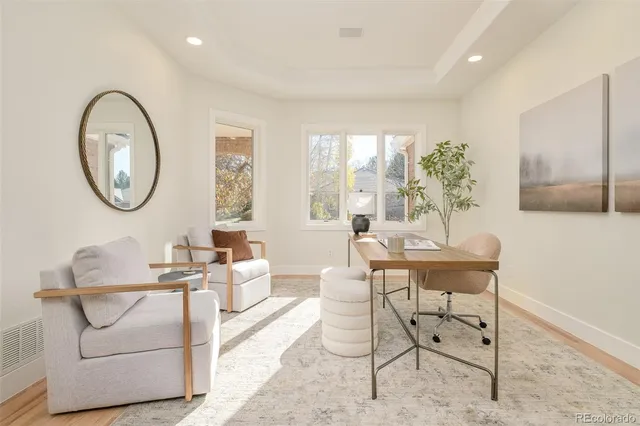 a large room with lots of white furniture