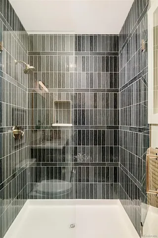 a living room with furniture and view of wooden floor