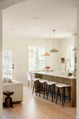 a large kitchen with kitchen island a large counter space a sink stainless steel appliances and cabinets