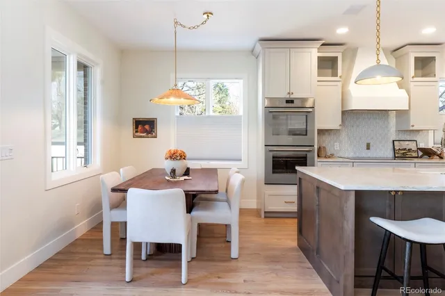a kitchen with granite countertop white cabinets and white appliances