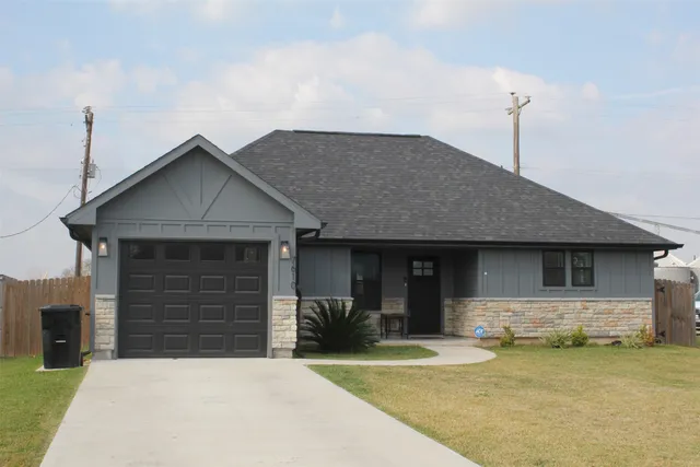 a front view of a house with a yard and garage