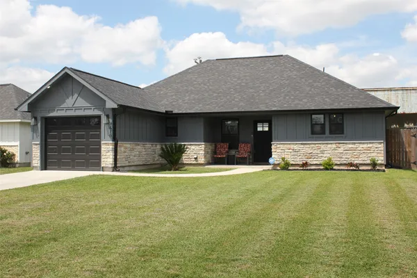 a front view of a house with a garden