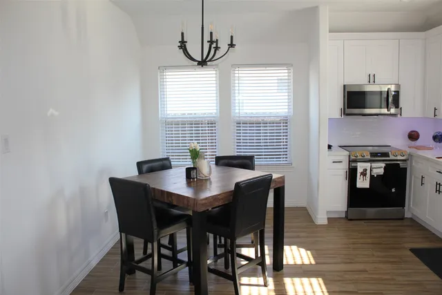 a view of a dining room with furniture window and wooden floor