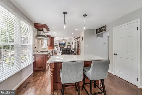 a kitchen with stainless steel appliances granite countertop a refrigerator a sink and a stove
