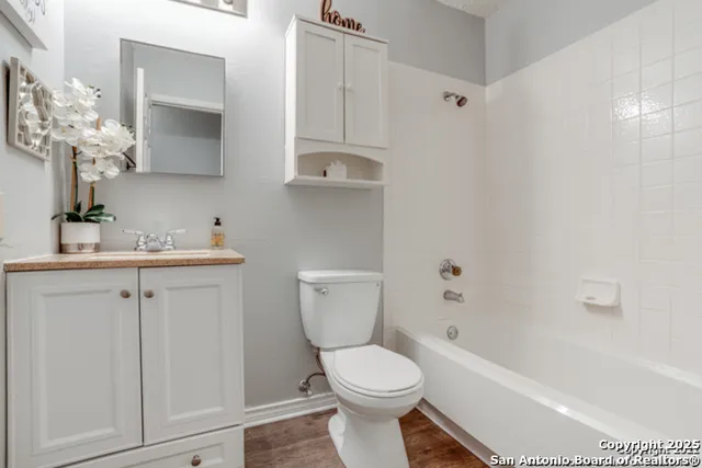 a bathroom with a sink a toilet and bathtub