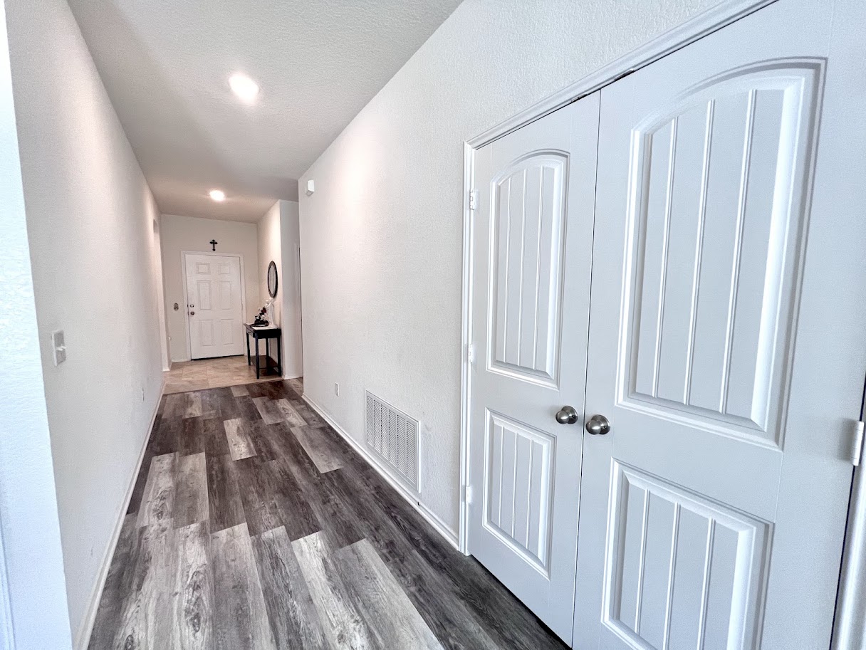 7900 Crystalbrook West Austin, TX 78724 - Photo 4 of 27 a view of a hallway with wooden floor and staircase