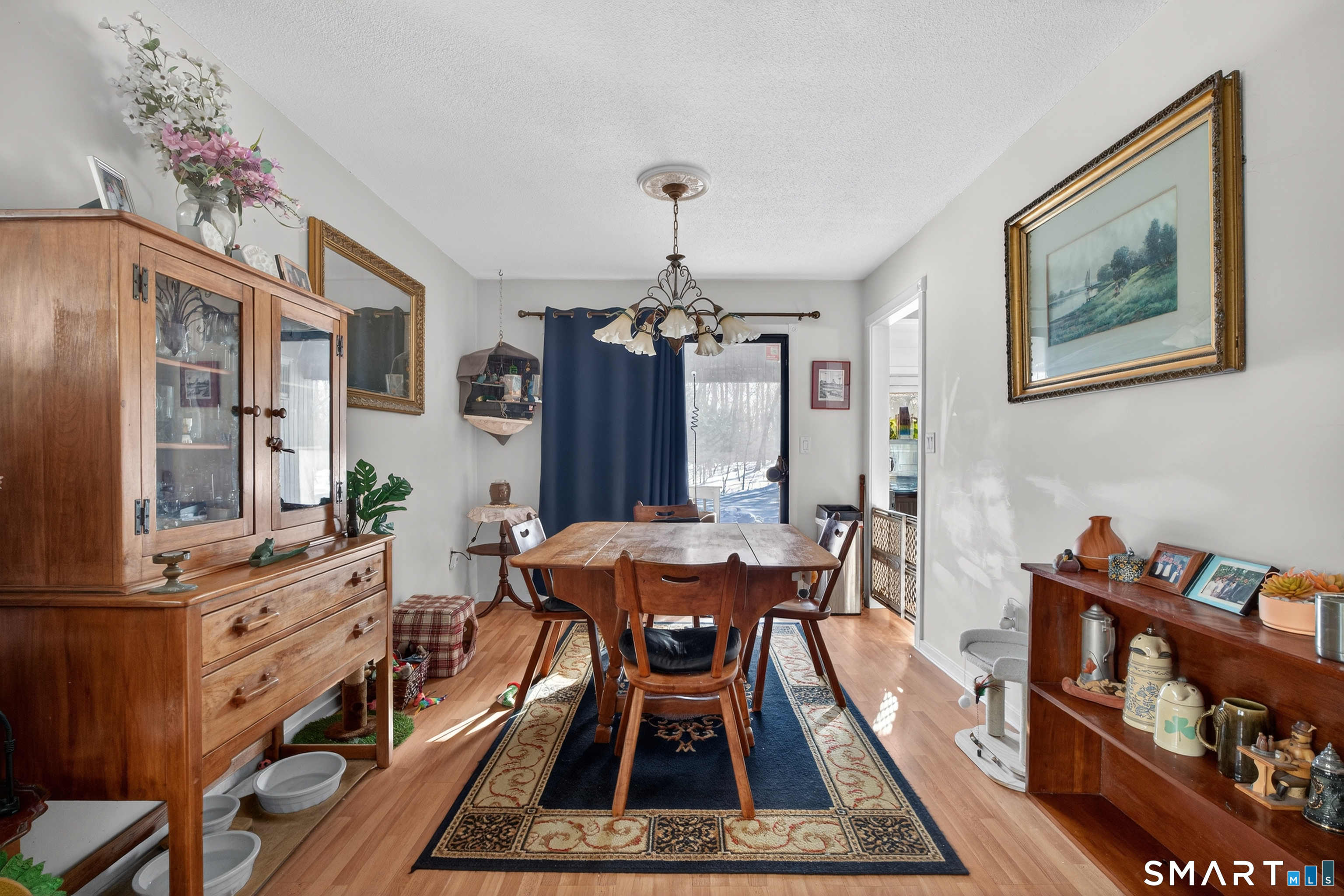 9 Upper Commons, Unit 9 Woodbury, CT 06798 - Photo 13 of 38 a dining room with furniture a rug and wooden floor