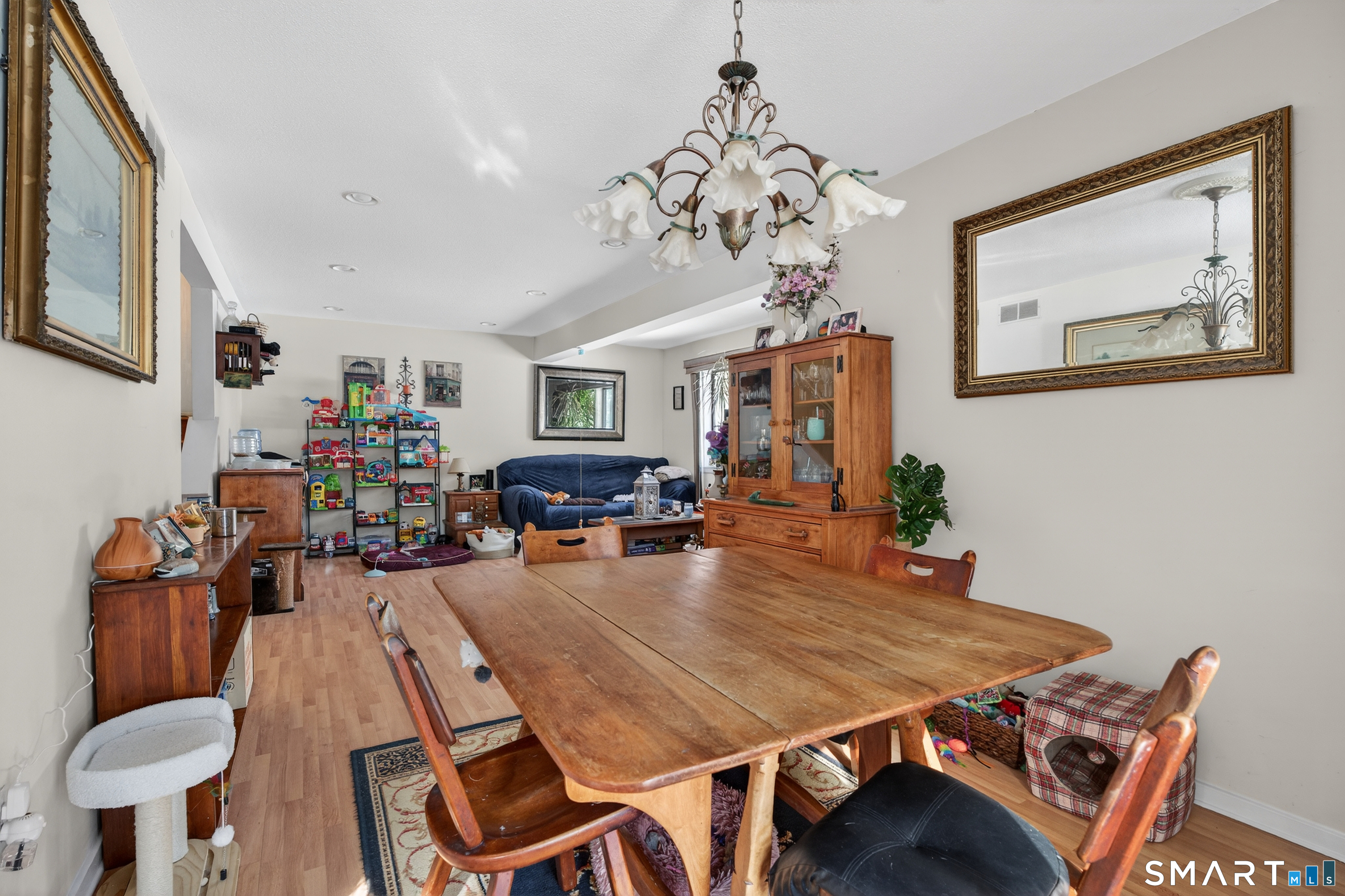 9 Upper Commons, Unit 9 Woodbury, CT 06798 - Photo 14 of 38 a dining room with furniture a chandelier and wooden floor