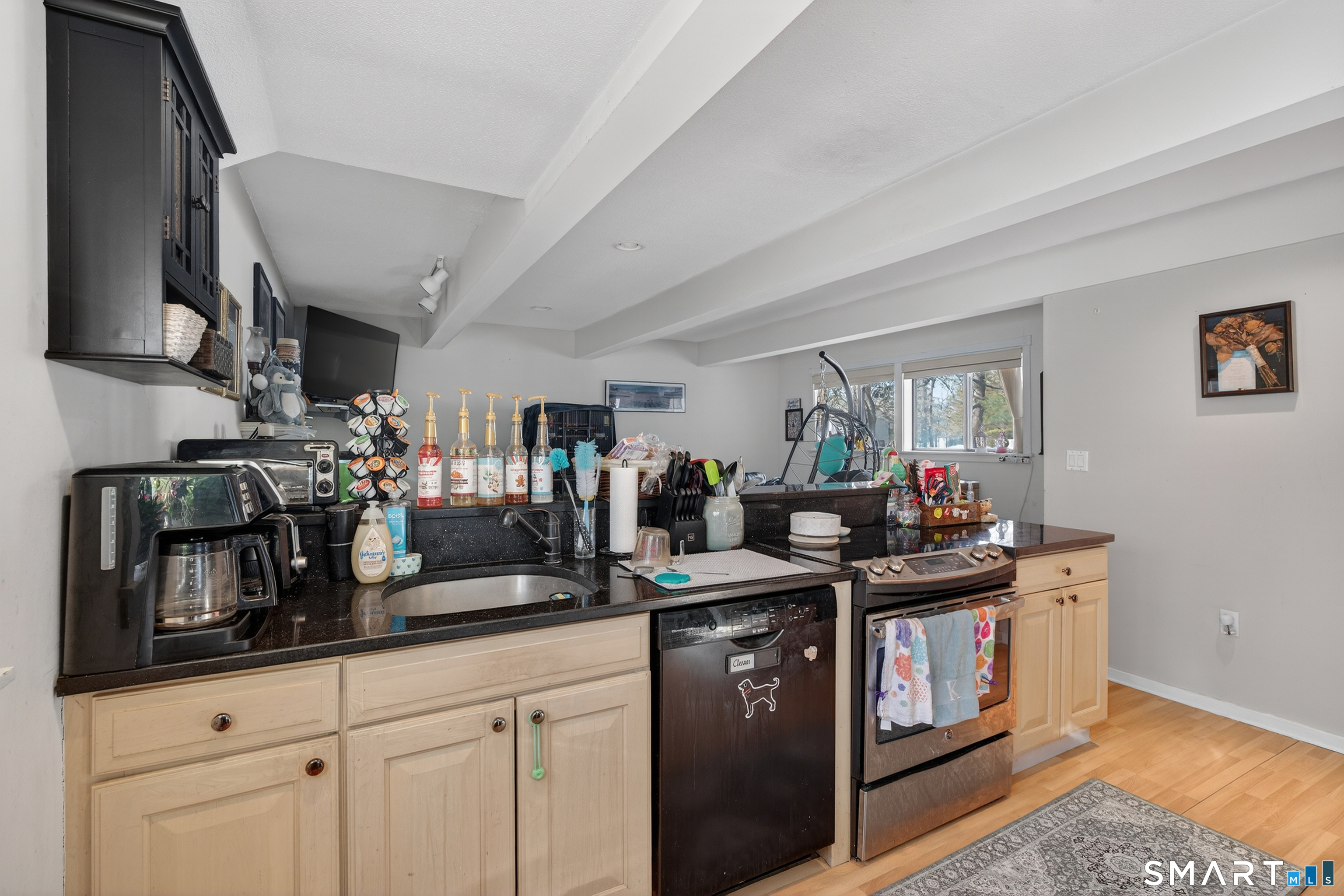 9 Upper Commons, Unit 9 Woodbury, CT 06798 - Photo 16 of 38 a kitchen with stainless steel appliances granite countertop a sink and cabinets
