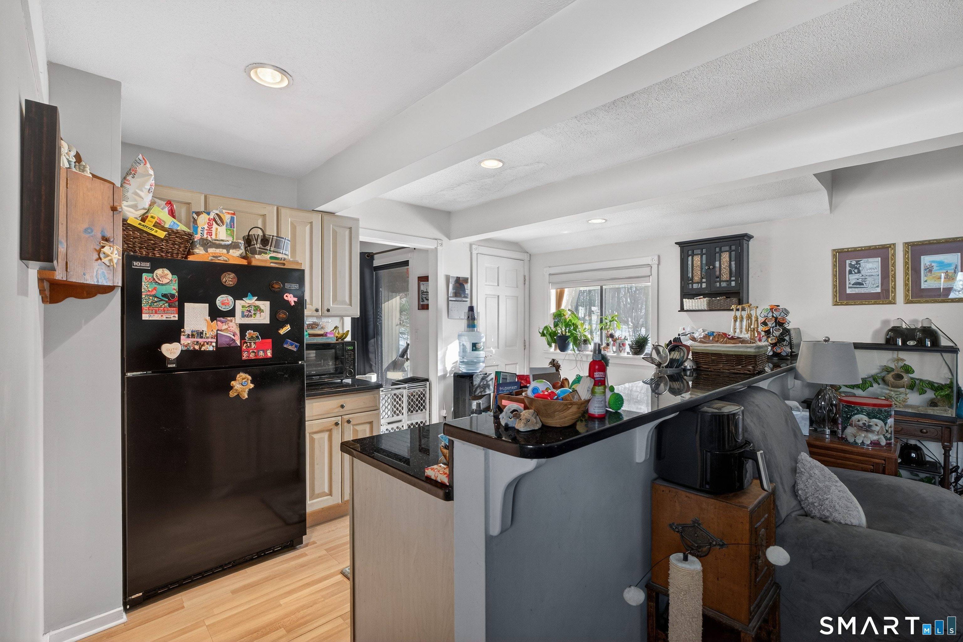 9 Upper Commons, Unit 9 Woodbury, CT 06798 - Photo 18 of 38 a view of a living room with furniture and cars