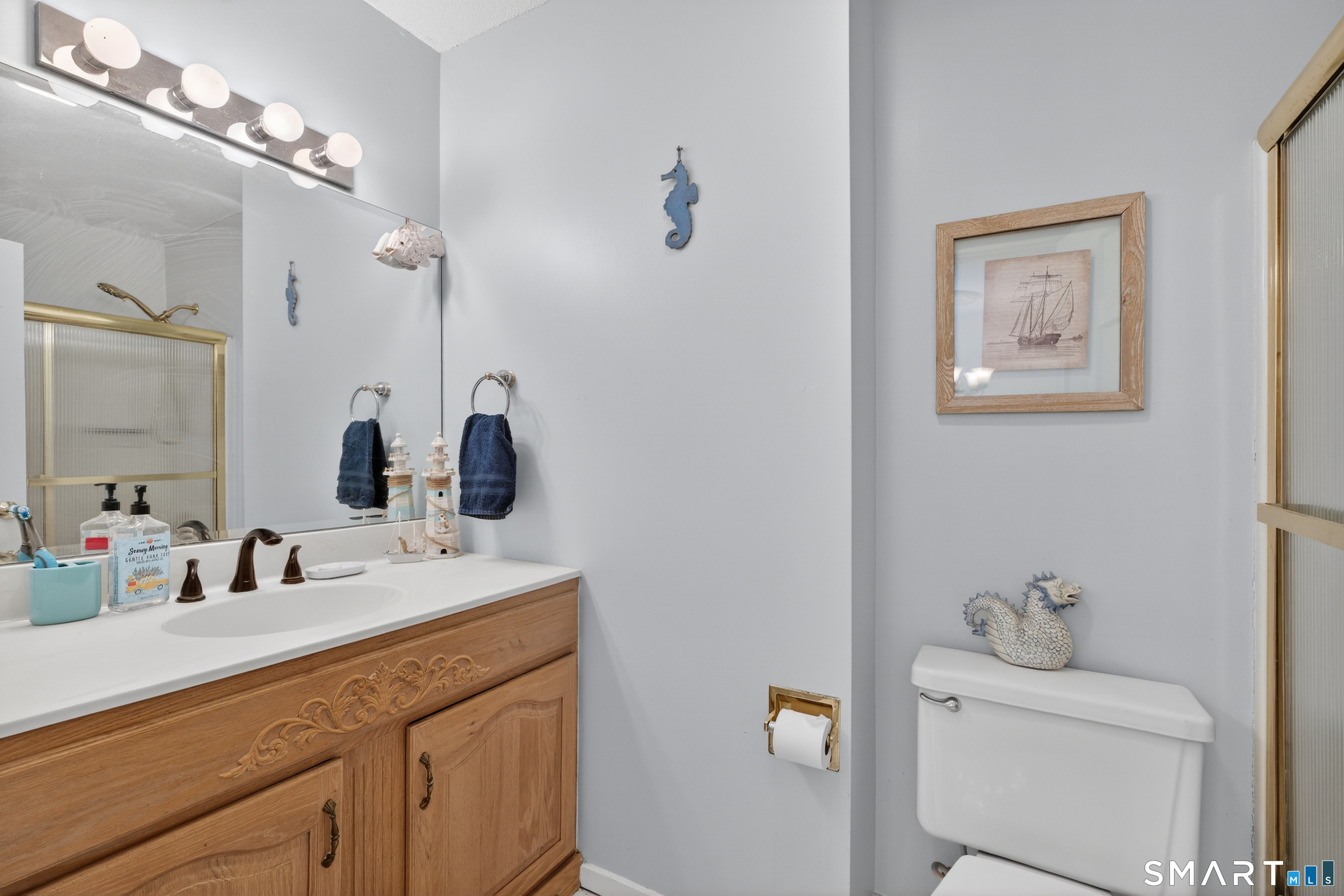 9 Upper Commons, Unit 9 Woodbury, CT 06798 - Photo 21 of 38 a bathroom with a double vanity sink and a mirror
