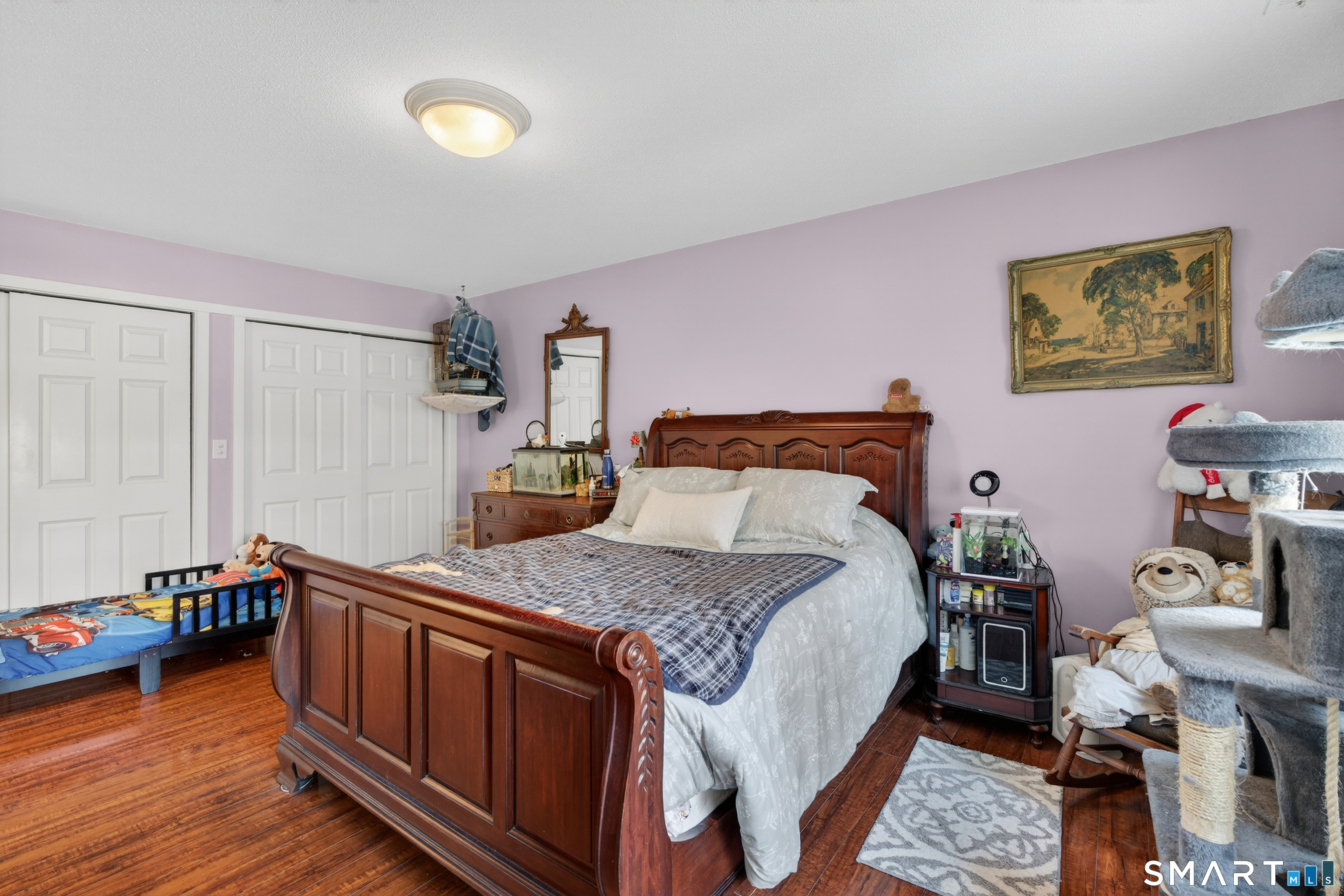 9 Upper Commons, Unit 9 Woodbury, CT 06798 - Photo 23 of 38 a bedroom with a bed and wooden floor