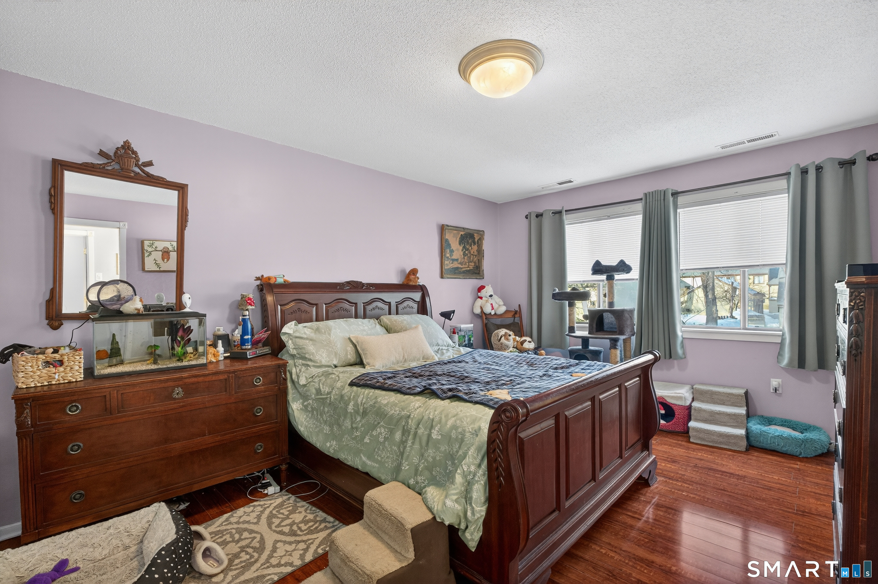 9 Upper Commons, Unit 9 Woodbury, CT 06798 - Photo 24 of 38 a bedroom with a bed and wooden floor