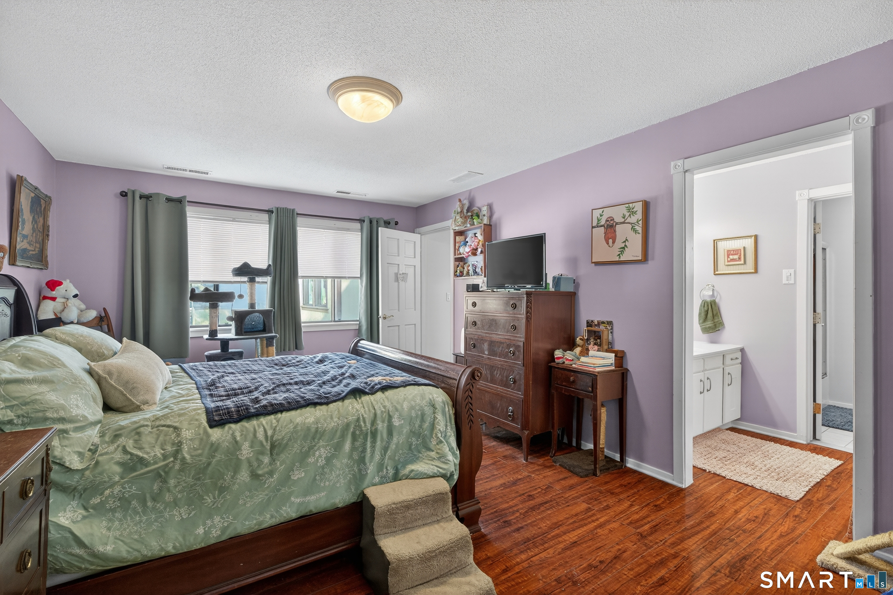 9 Upper Commons, Unit 9 Woodbury, CT 06798 - Photo 25 of 38 a living room with furniture and a flat screen tv