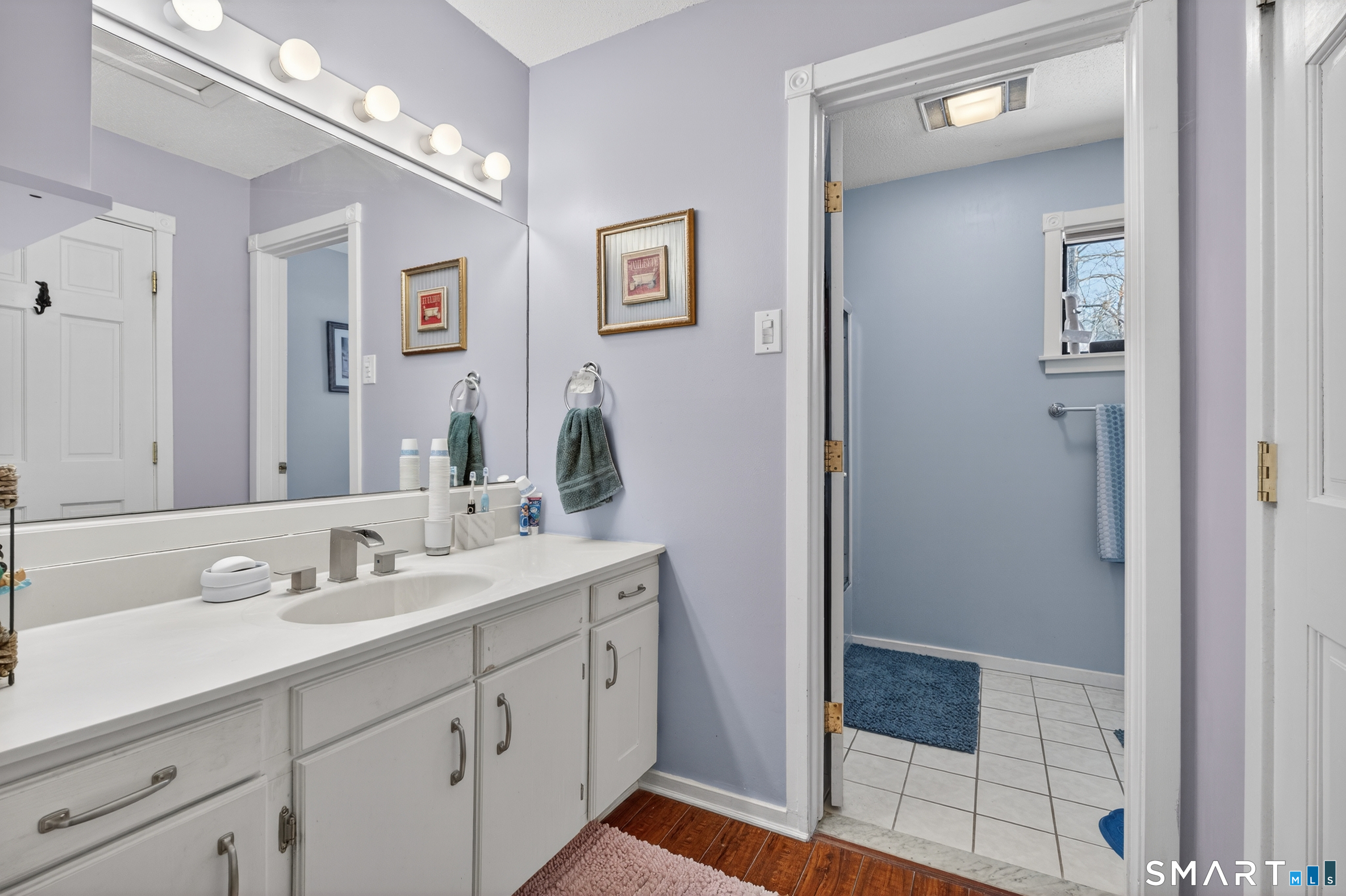 9 Upper Commons, Unit 9 Woodbury, CT 06798 - Photo 26 of 38 a bathroom with a double vanity sink and a mirror