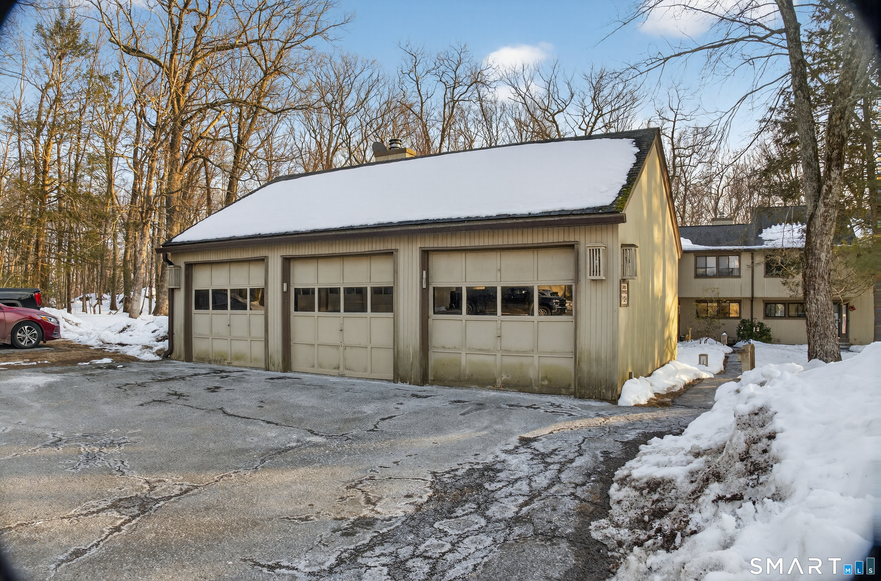 9 Upper Commons, Unit 9 Woodbury, CT 06798 - Photo 34 of 38 a front view of a house with a yard covered in snow