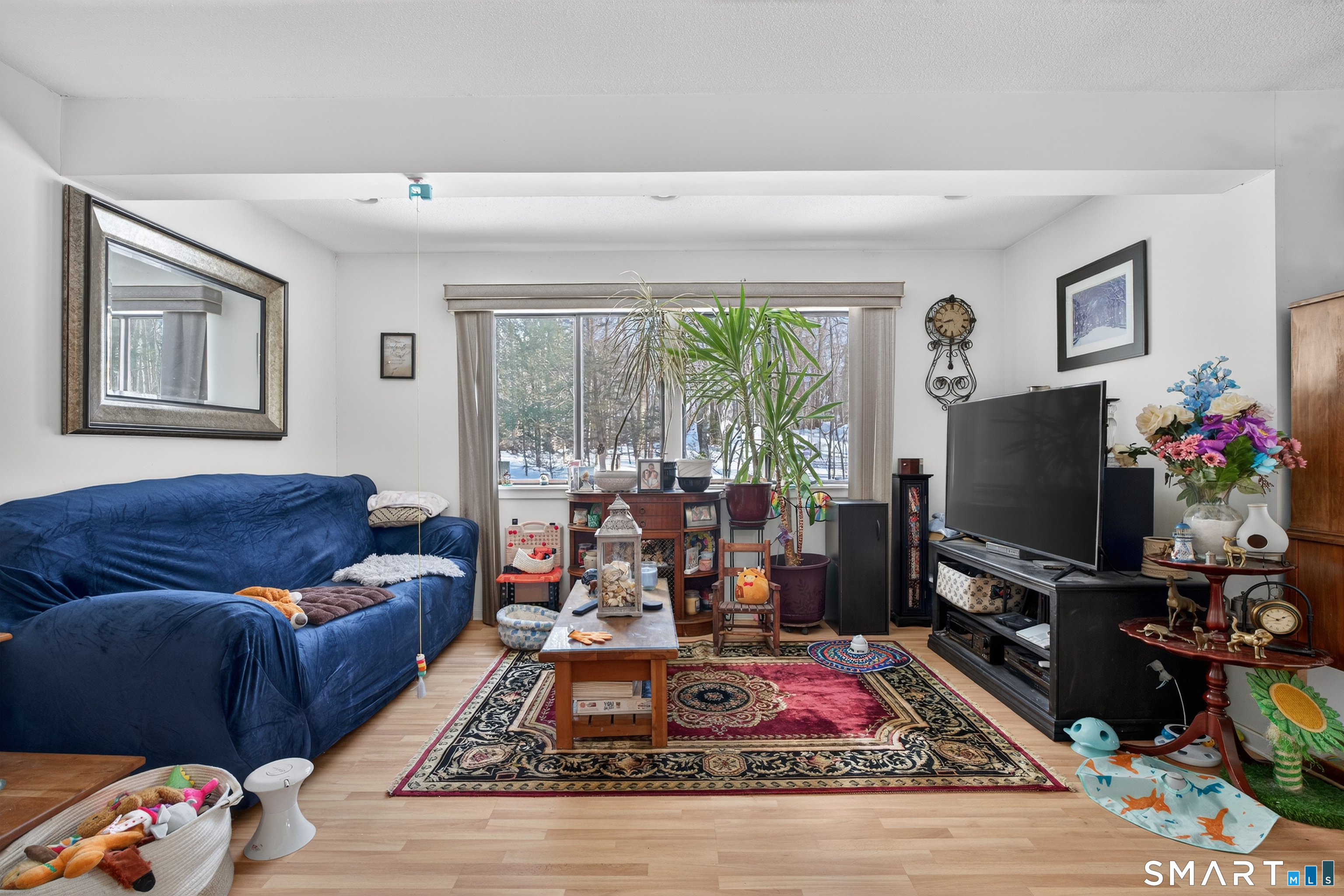 9 Upper Commons, Unit 9 Woodbury, CT 06798 - Photo 7 of 38 a living room with furniture flat screen tv and a floor to ceiling window