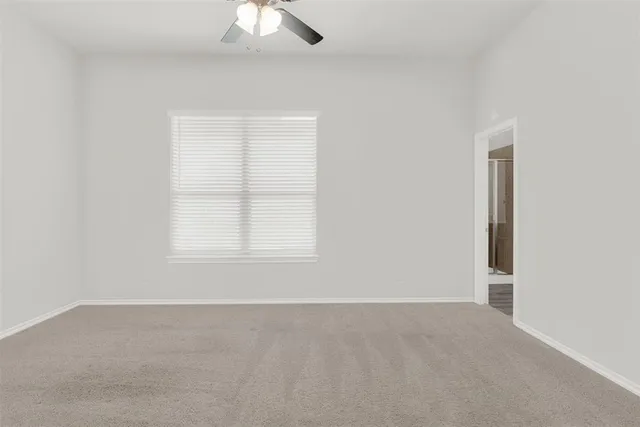 a large kitchen with a large counter top a sink a counter space and stainless steel appliances