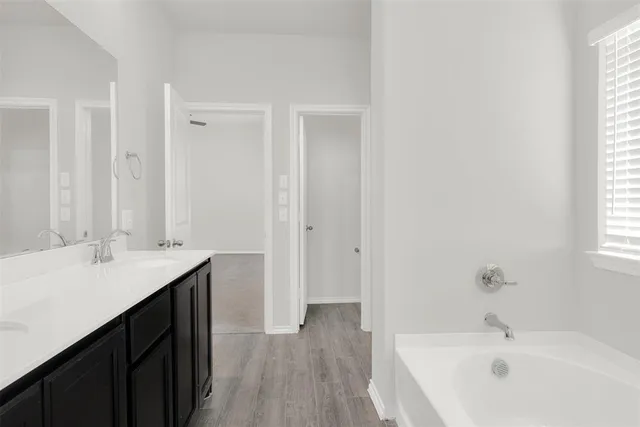 a bathroom with a bathtub and a shower