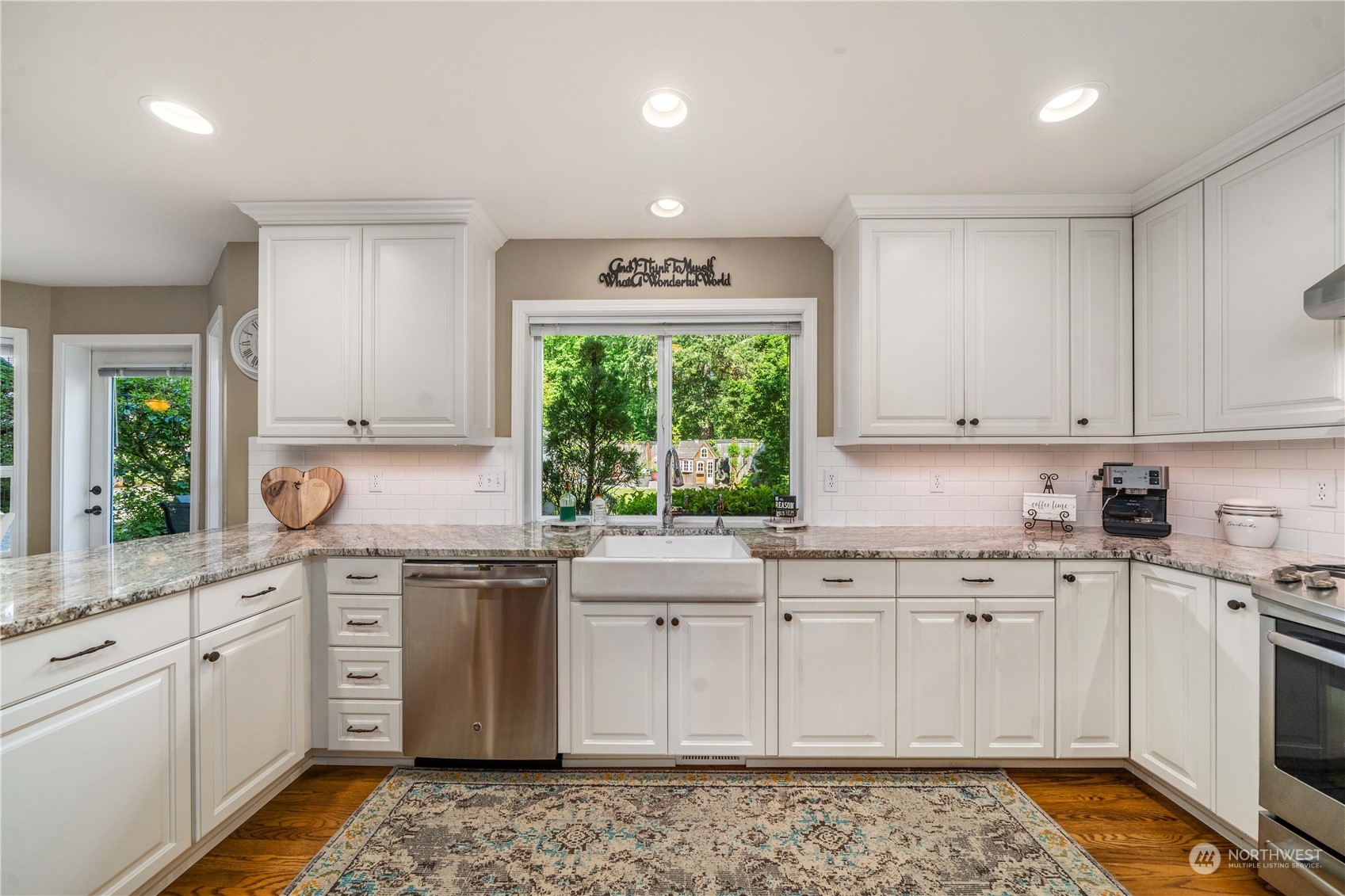 17811 87th Avenue East Puyallup, WA 98375 - Photo 11 of 37 a kitchen with granite countertop white cabinets and white appliances