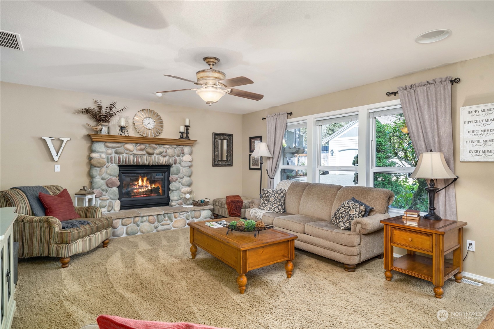 17811 87th Avenue East Puyallup, WA 98375 - Photo 15 of 37 a living room with furniture a fireplace and a large window