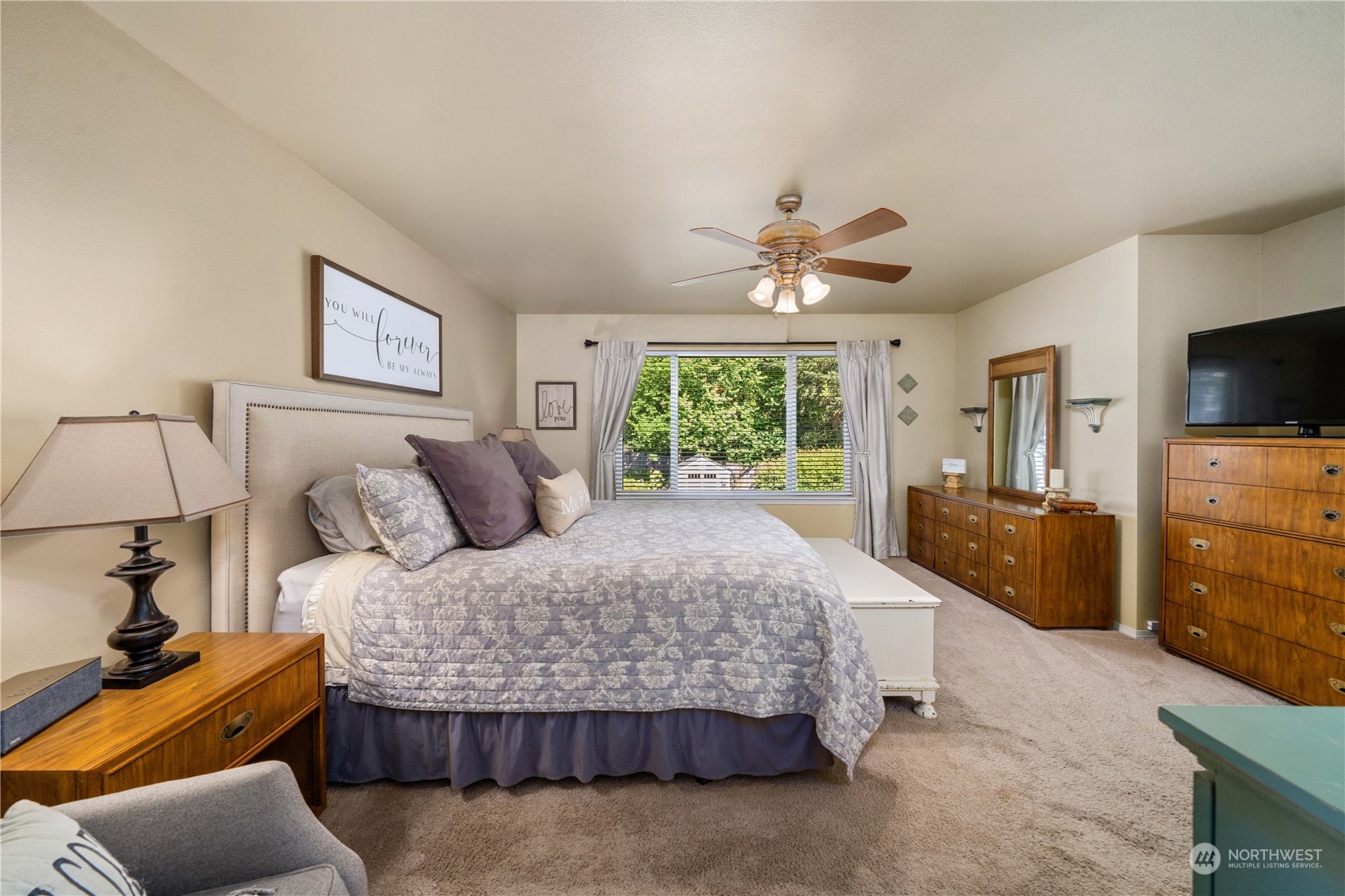 17811 87th Avenue East Puyallup, WA 98375 - Photo 18 of 37 a bedroom with a bed and a flat screen tv