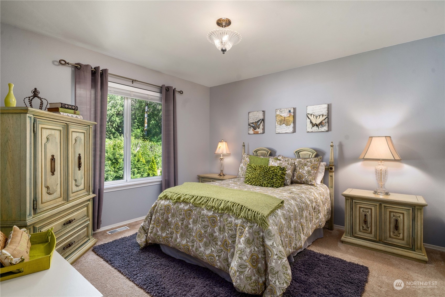 17811 87th Avenue East Puyallup, WA 98375 - Photo 22 of 37 a bedroom with a bed a dresser and next to a window