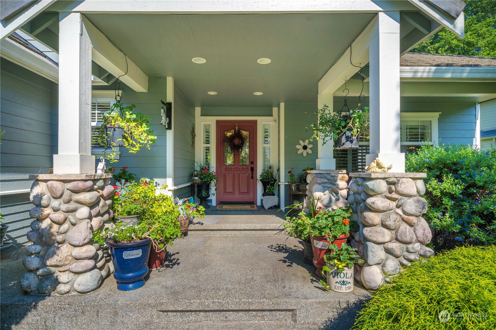 17811 87th Avenue East Puyallup, WA 98375 - Photo 3 of 37 a front view of a house with lots of flowers