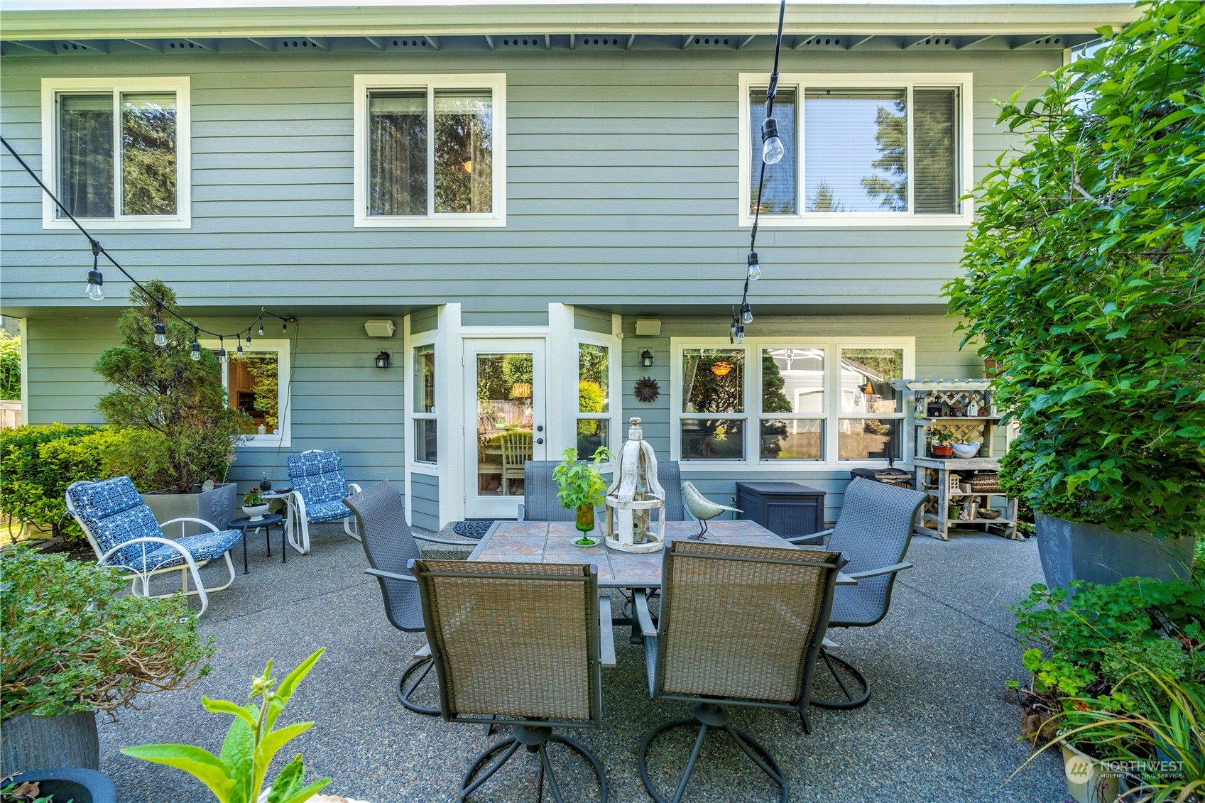 17811 87th Avenue East Puyallup, WA 98375 - Photo 33 of 37 a view of a patio with table and chairs and potted plants