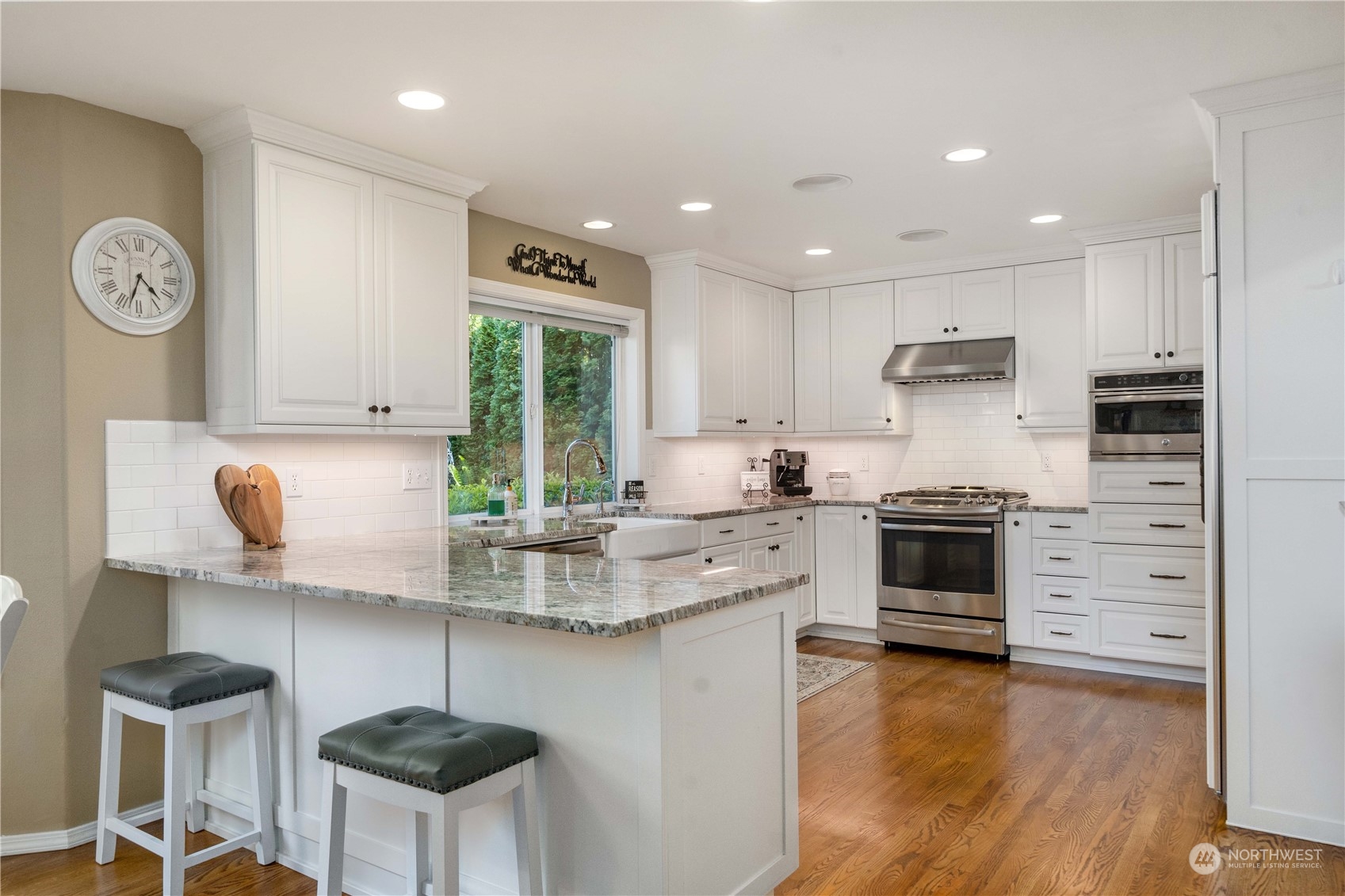17811 87th Avenue East Puyallup, WA 98375 - Photo 10 of 37 a kitchen with stainless steel appliances granite countertop a stove a sink and a refrigerator