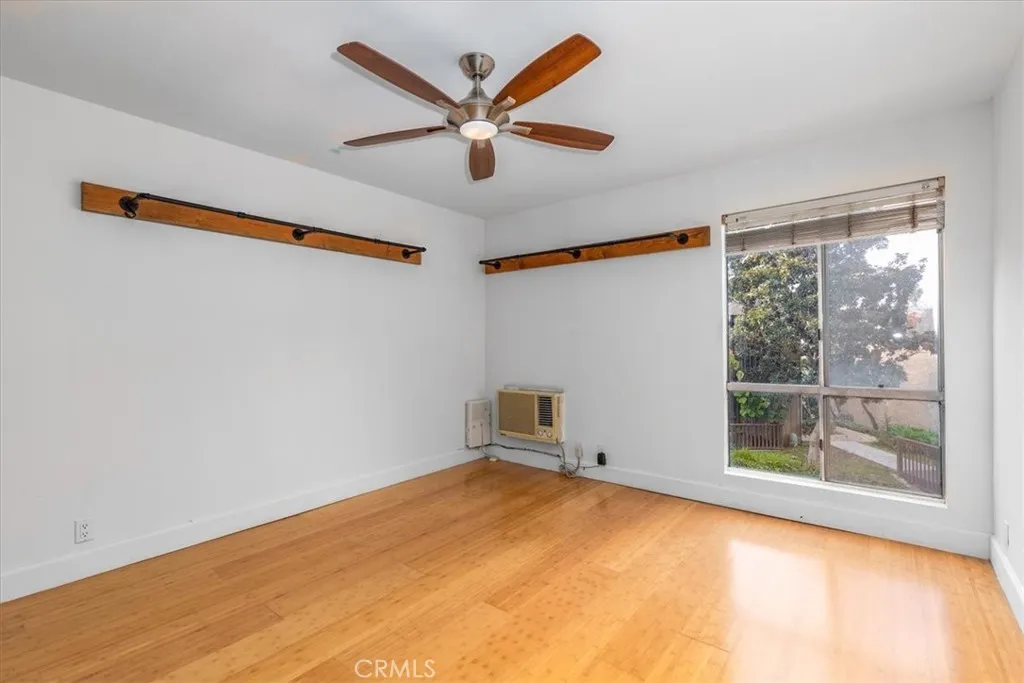 7890 East Spring Street, Unit 18F Long Beach, CA 90802 - Photo 11 of 31 a view of room with window and ceiling fan